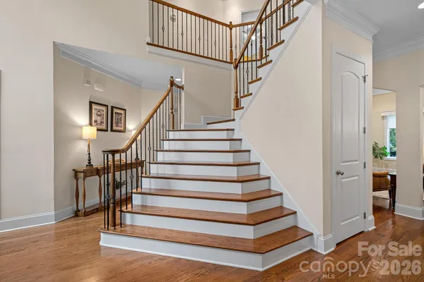 a view of entryway and hall with wooden floor