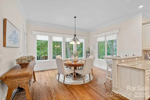 a dining room with furniture mountain view and wooden floor