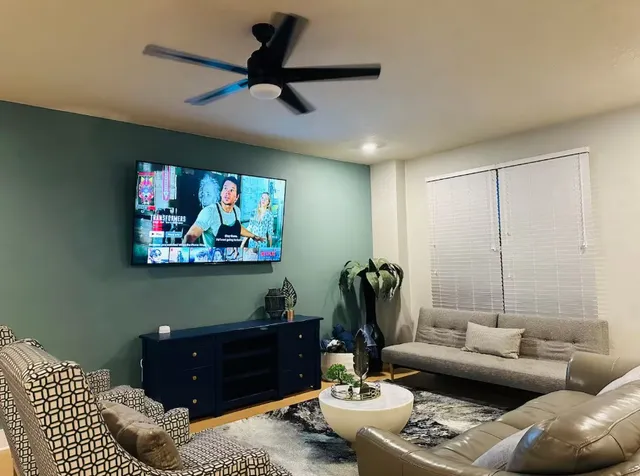 a living room with furniture and a flat screen tv