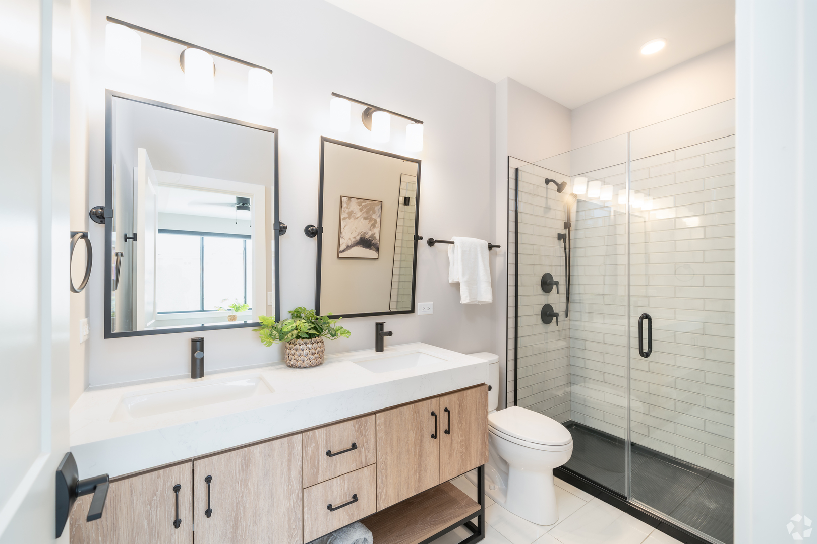 181 Pointe Drive, Unit 181 Northbrook, IL 60062 - Photo 14 of 25 a bathroom with a double vanity sink toilet and shower
