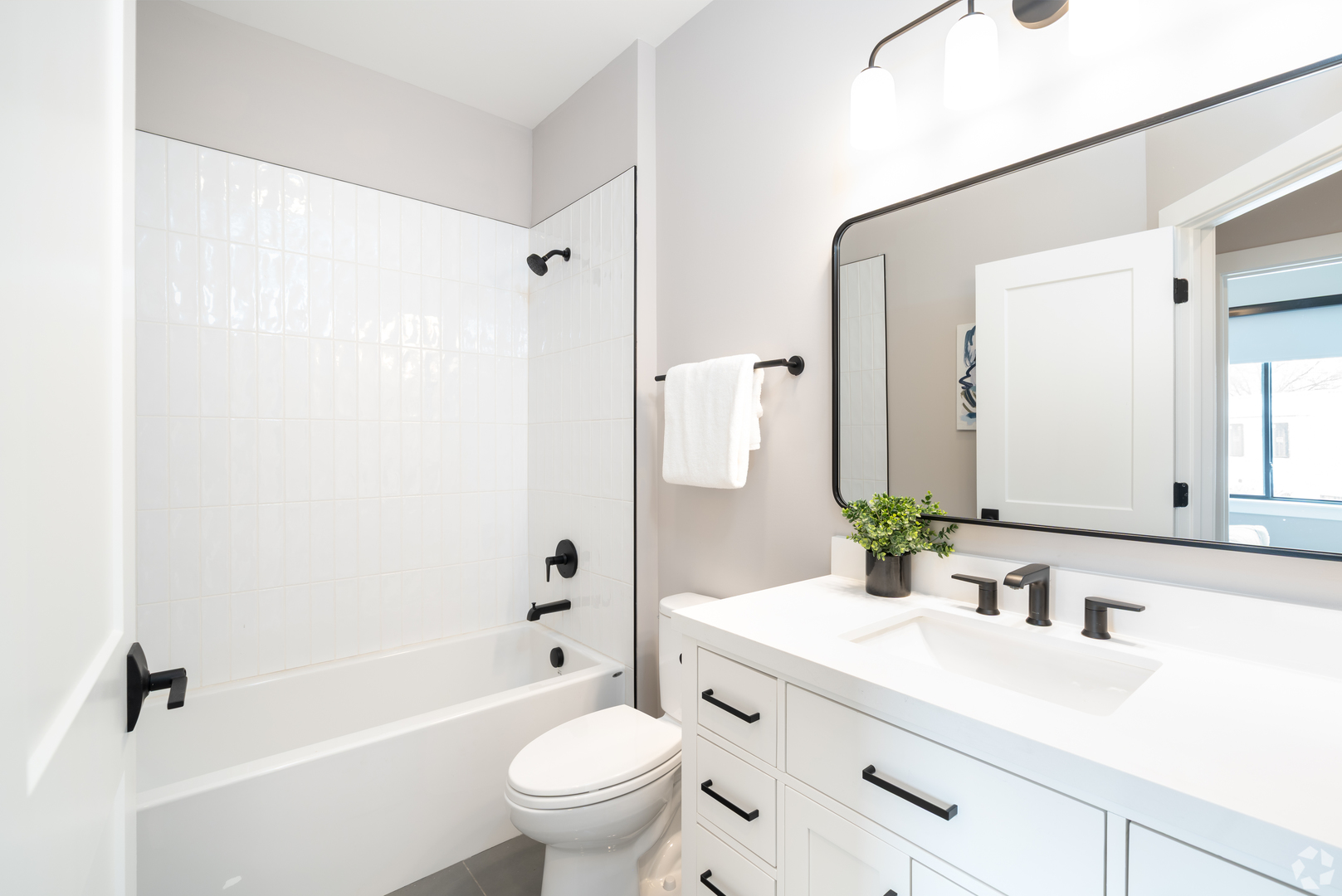 181 Pointe Drive, Unit 181 Northbrook, IL 60062 - Photo 22 of 25 a bathroom with a sink a toilet a mirror a vanity and shower