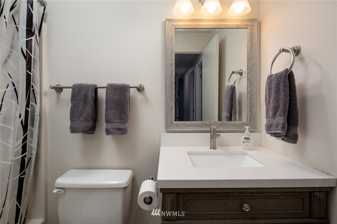 3 Barn View Drive, Unit 5 Bellingham, WA 98229 - Photo 18 of 25 a bathroom with a sink a toilet and mirror