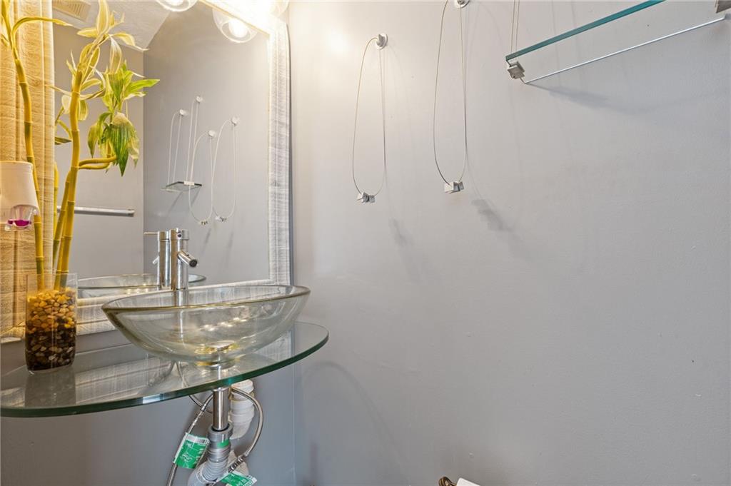 7035 Red Maple Lane Lithonia, GA 30058 - Photo 19 of 37 a bathroom with a sink and a mirror