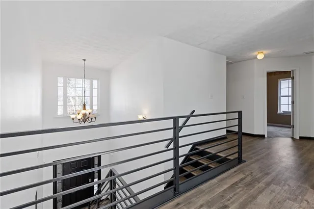 a view of entryway and hall with wooden floor