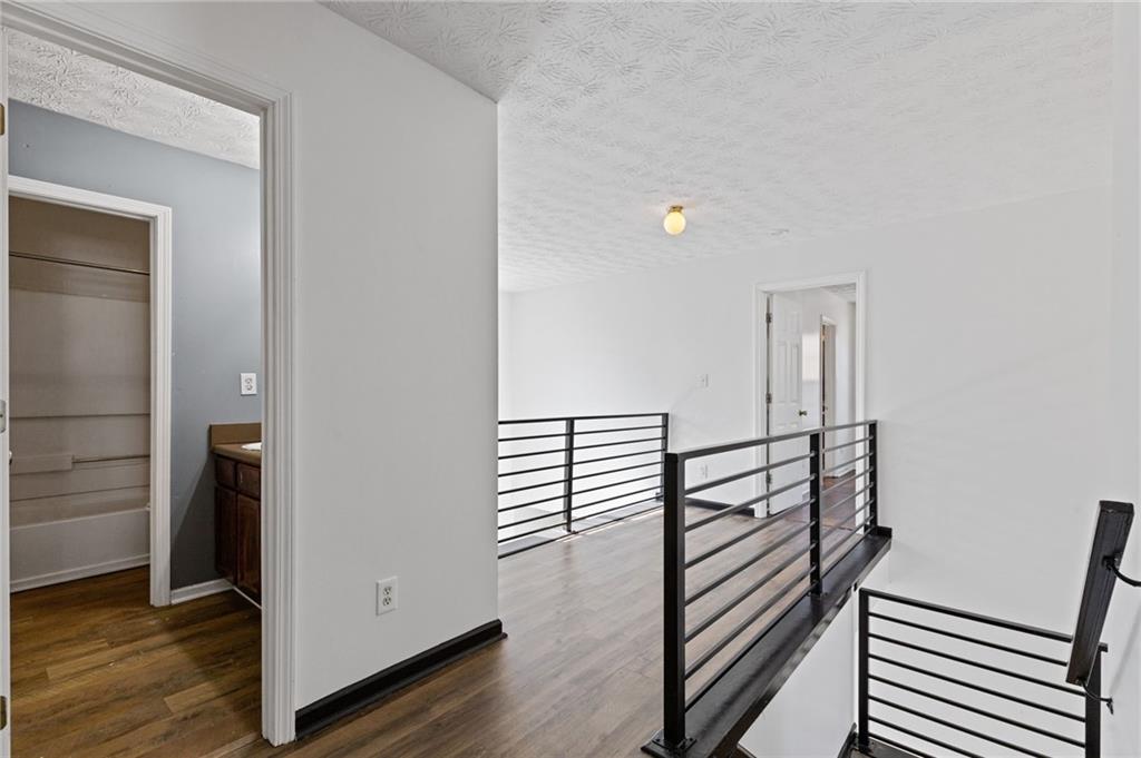 7035 Red Maple Lane Lithonia, GA 30058 - Photo 25 of 37 a view of a hallway with wooden floor and stairs