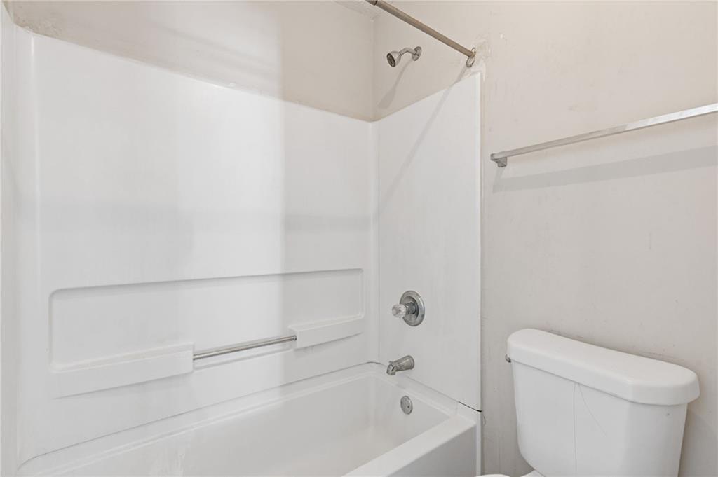 7035 Red Maple Lane Lithonia, GA 30058 - Photo 27 of 37 a bathroom with a bathtub and a toilet