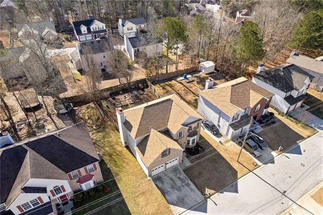 an aerial view of a house with a yard
