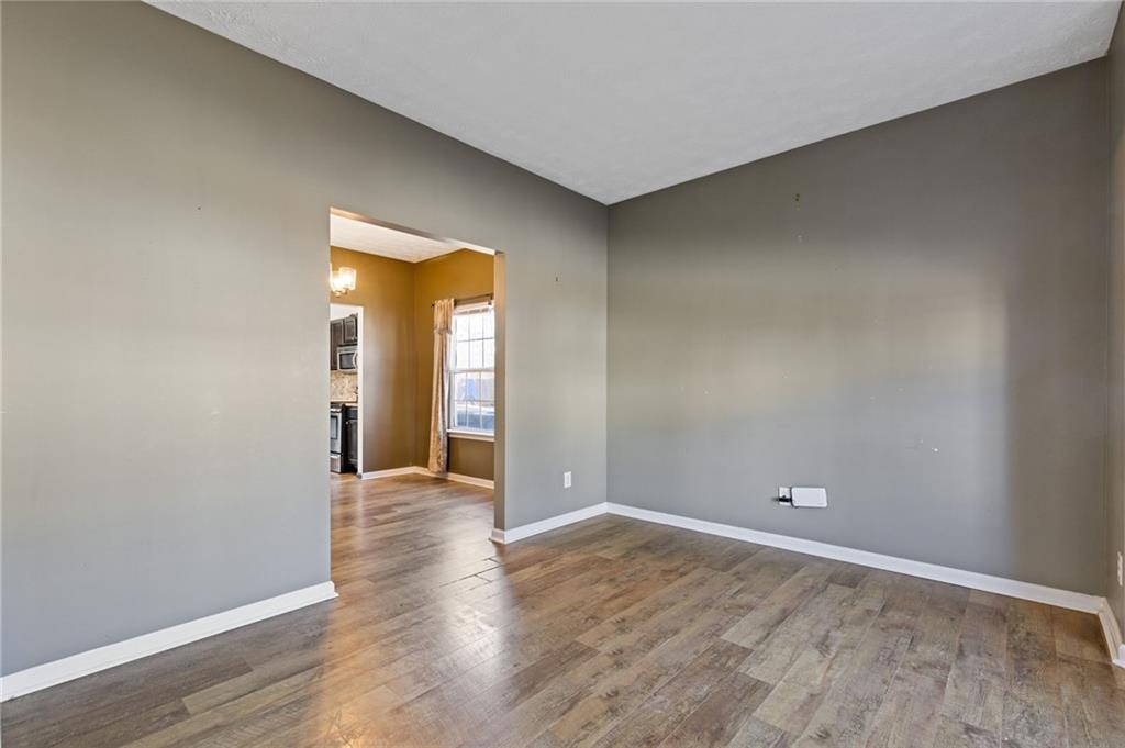 7035 Red Maple Lane Lithonia, GA 30058 - Photo 7 of 37 a view of an empty room with wooden floor and closet