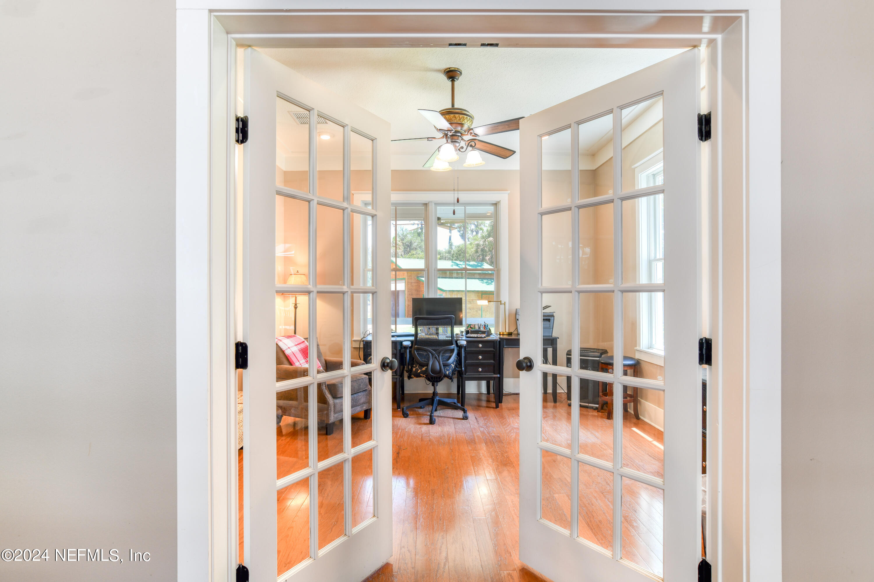 560 Clifton Road Crescent City, FL 32112 - Photo 12 of 73 a dining room with wooden floor a chandelier a glass table and windows