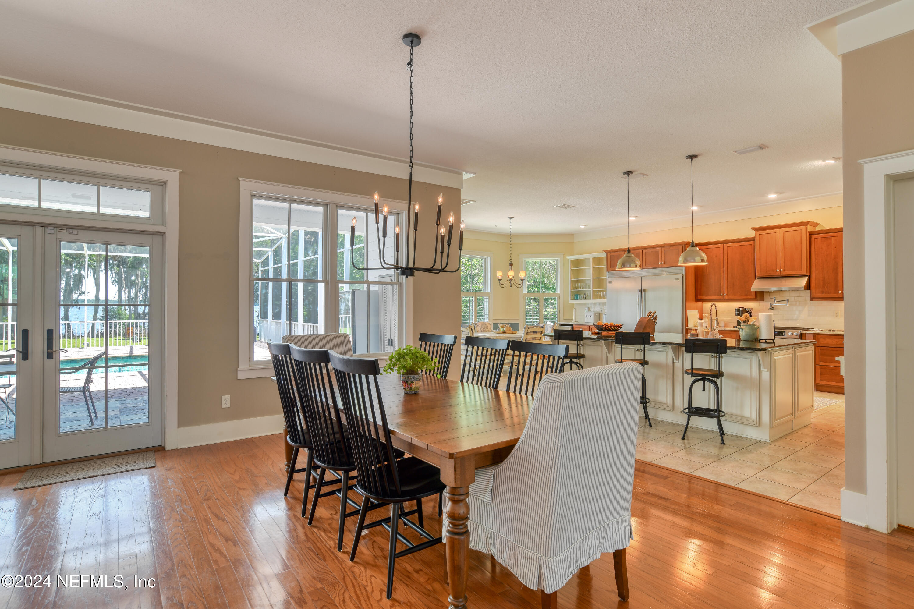 560 Clifton Road Crescent City, FL 32112 - Photo 15 of 73 a view of a dining room and livingroom with furniture wooden floor a chandelier