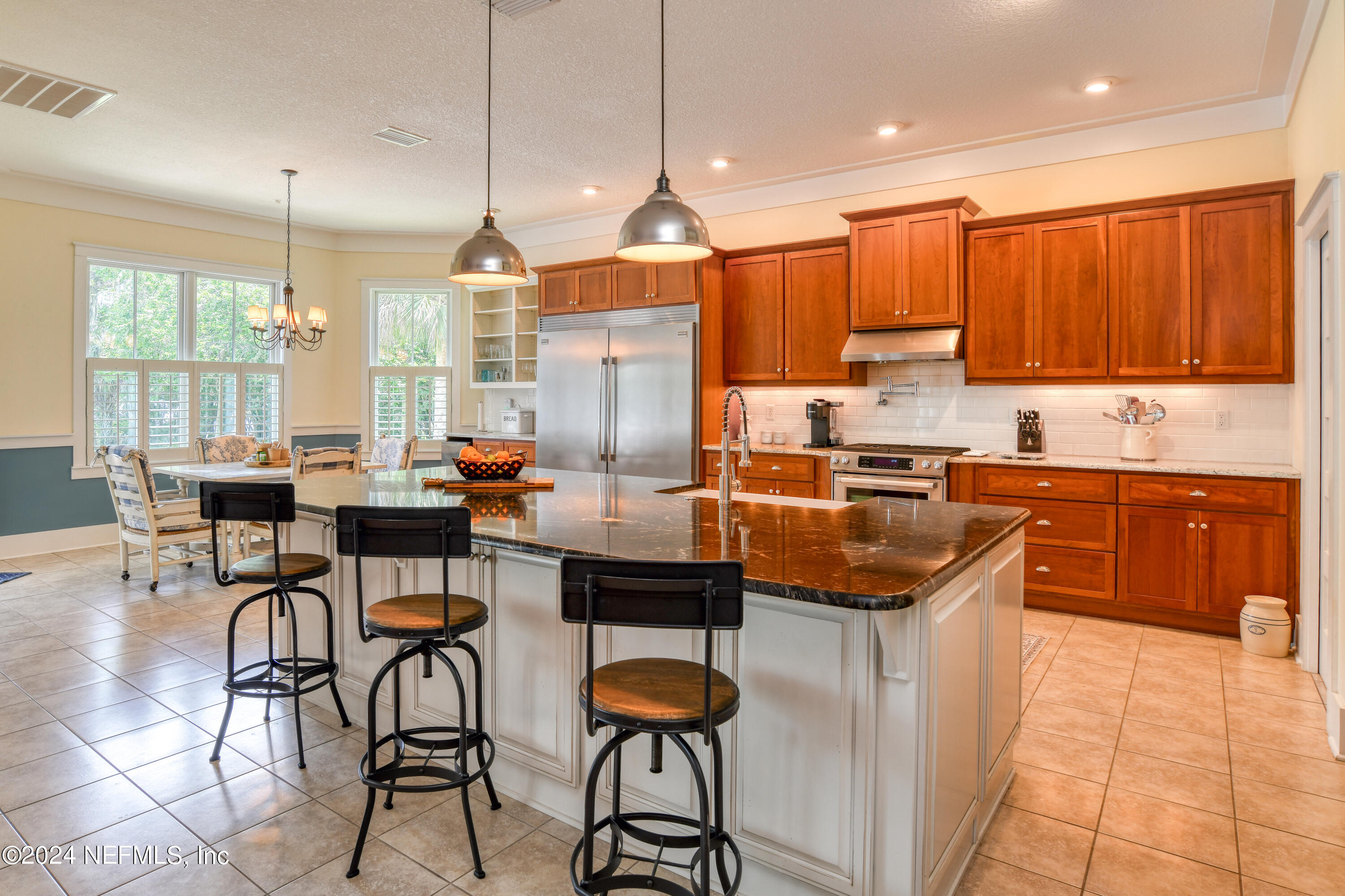 560 Clifton Road Crescent City, FL 32112 - Photo 35 of 73 a kitchen with stainless steel appliances kitchen island granite countertop a sink and cabinets