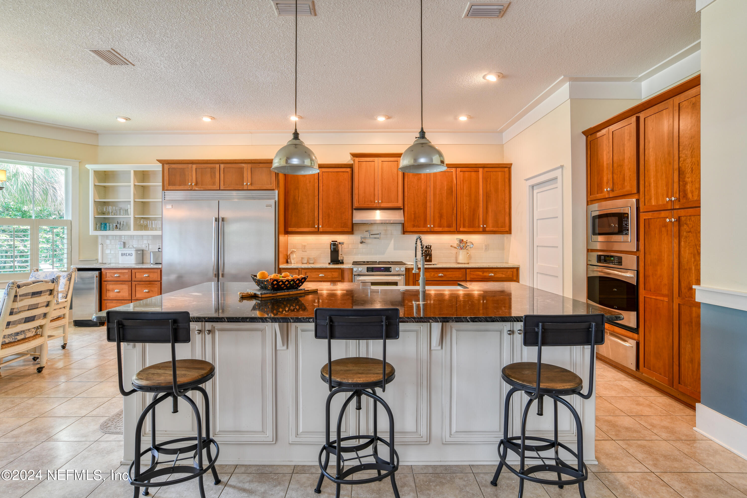 560 Clifton Road Crescent City, FL 32112 - Photo 36 of 73 a kitchen with stainless steel appliances kitchen island granite countertop a stove a sink and a refrigerator