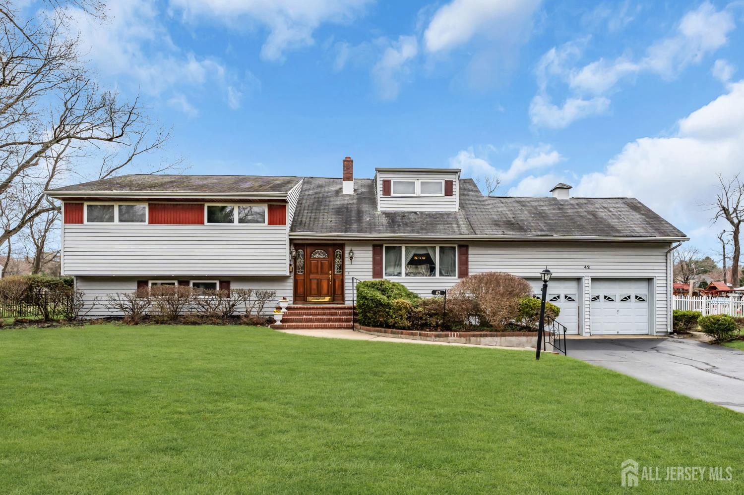 42 Riveredge Road Tinton Falls, NJ 07724 - Photo 1 of 41 a front view of a house with garden