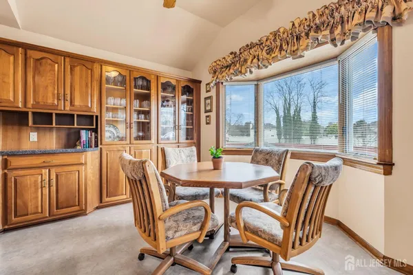 a dining room with furniture mountain view and large windows