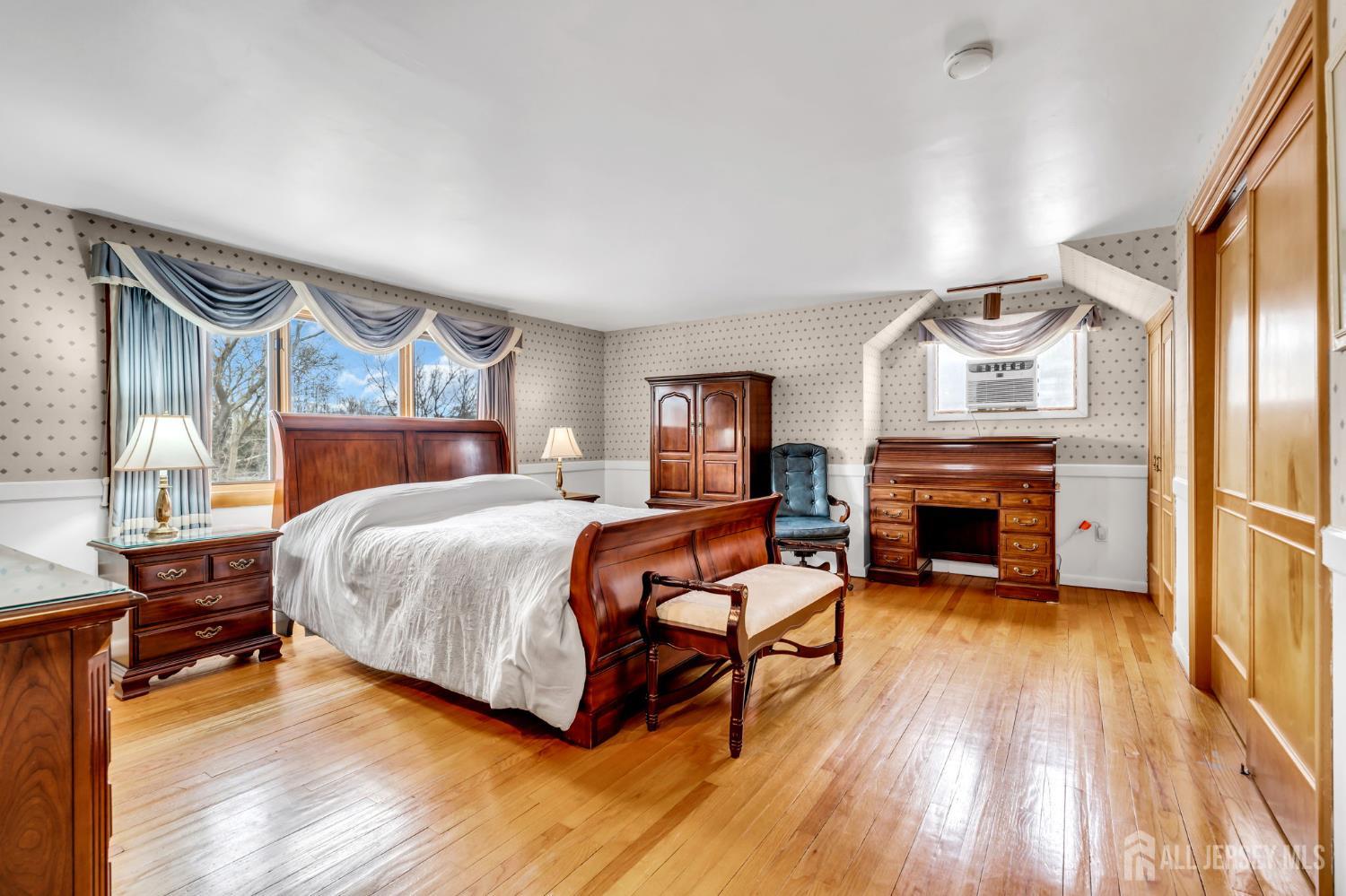 42 Riveredge Road Tinton Falls, NJ 07724 - Photo 18 of 41 a spacious bedroom with a bed and a fireplace