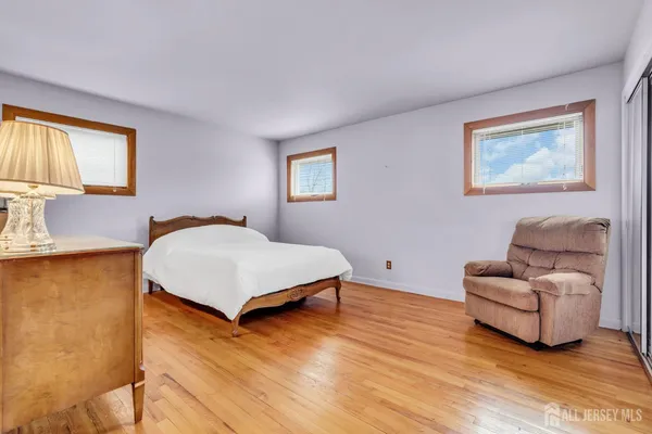 a bedroom with furniture and a large window