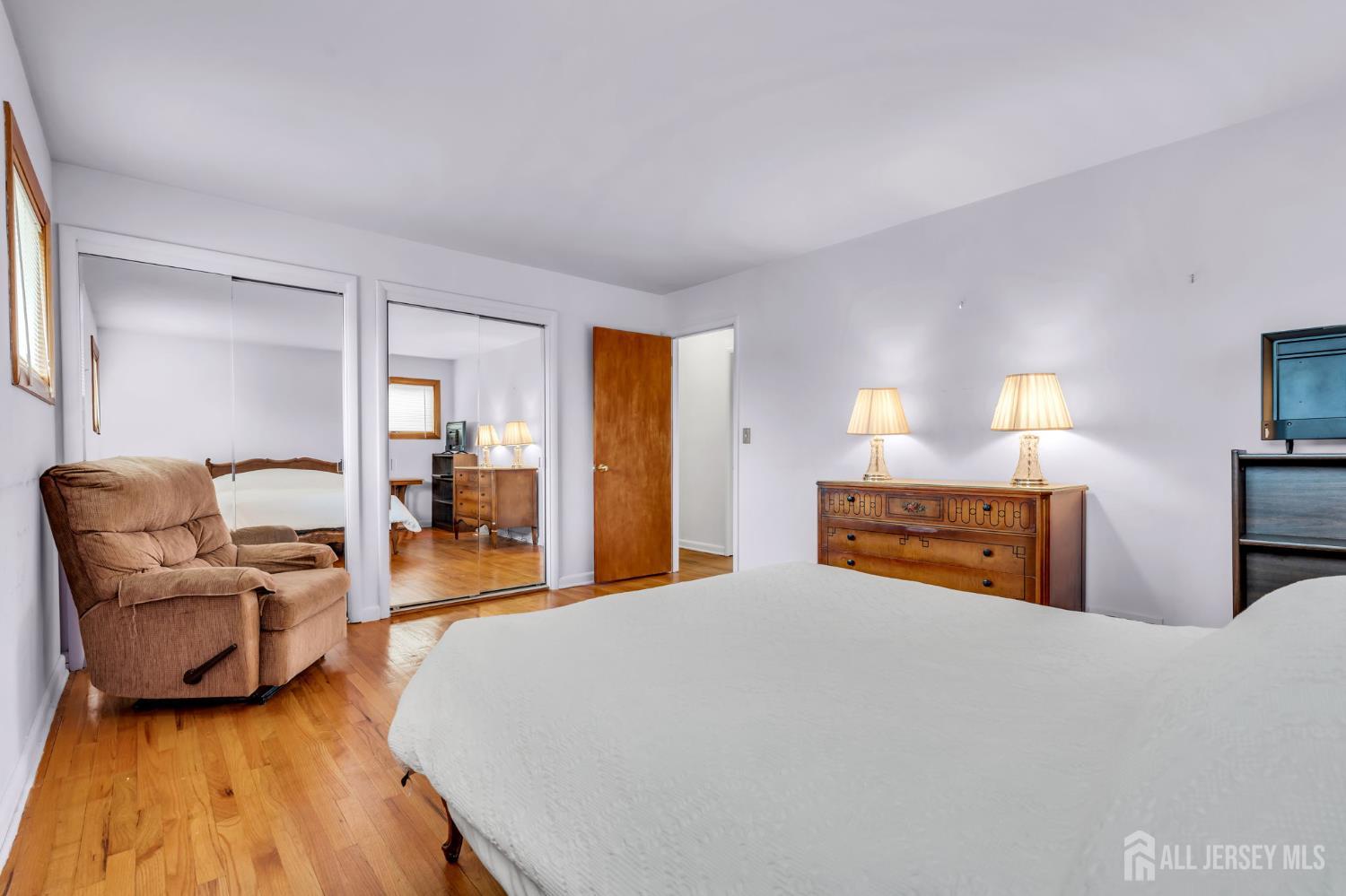 42 Riveredge Road Tinton Falls, NJ 07724 - Photo 24 of 41 a bedroom with a bed and wooden floor