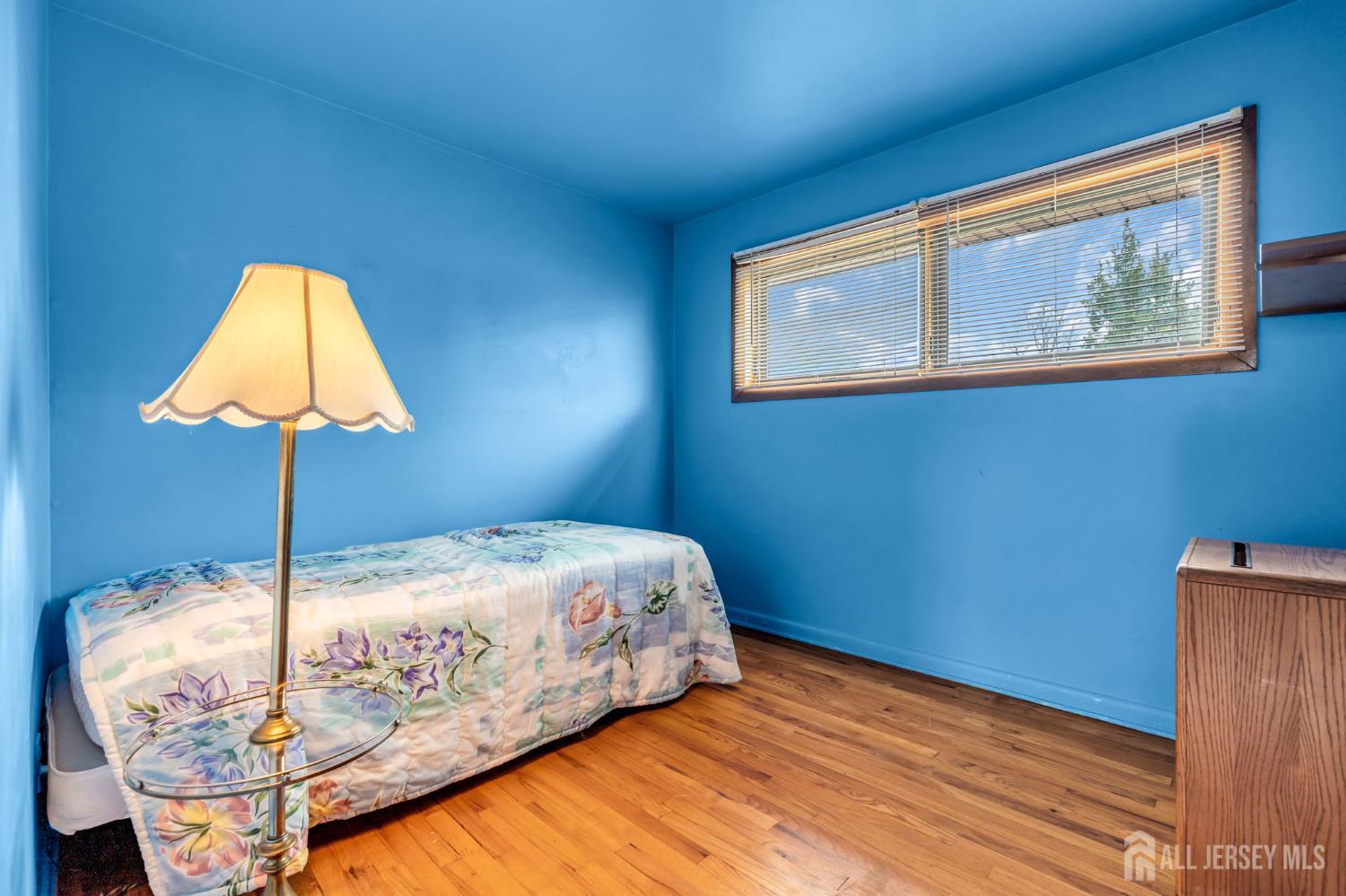 42 Riveredge Road Tinton Falls, NJ 07724 - Photo 26 of 41 a bed sitting in a bedroom next to a lamp