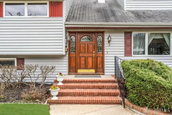 a front view of a house with a garden
