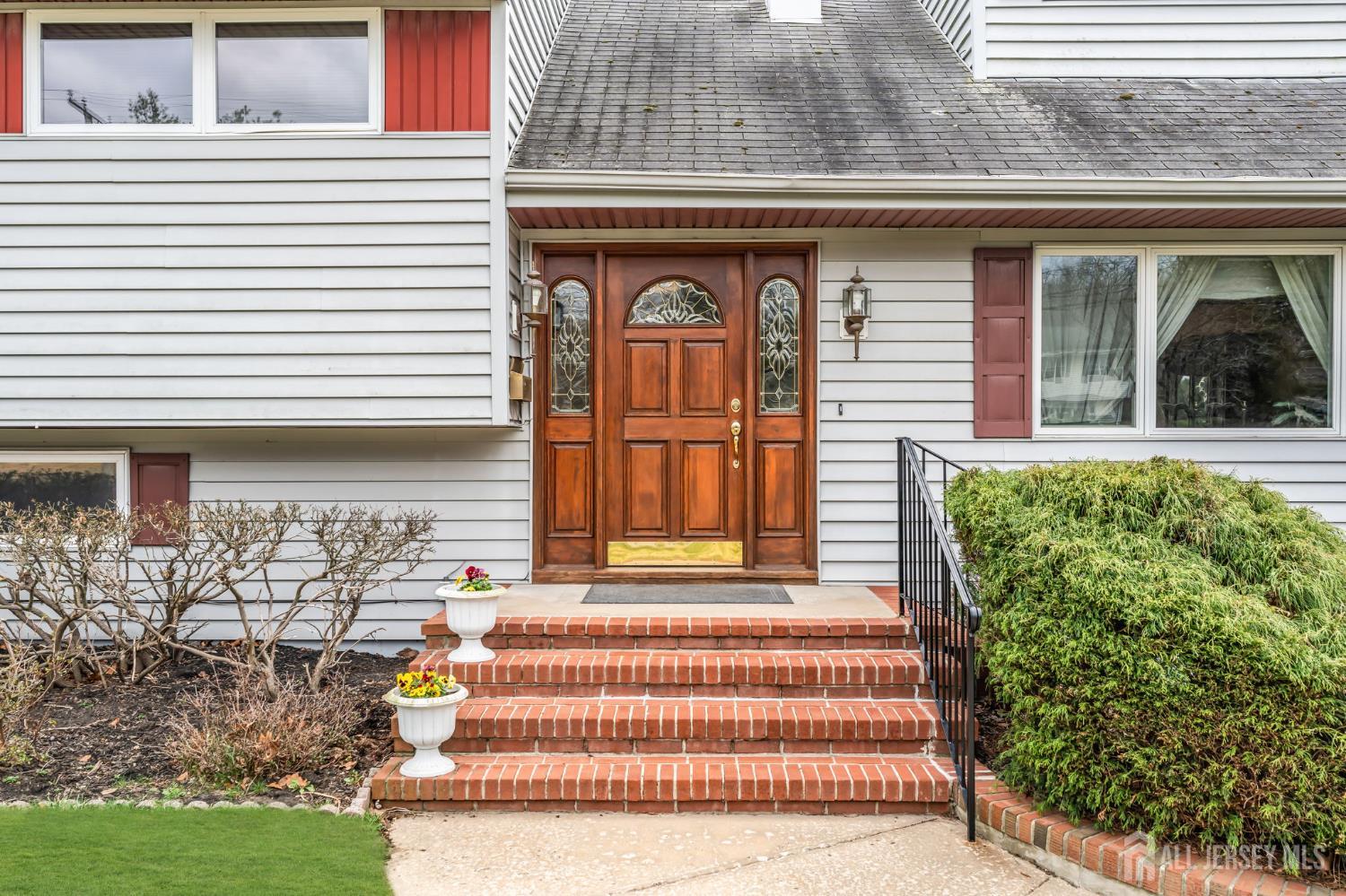 42 Riveredge Road Tinton Falls, NJ 07724 - Photo 3 of 41 a front view of a house with a garden