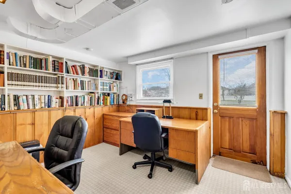 a workspace with furniture and a bookshelf