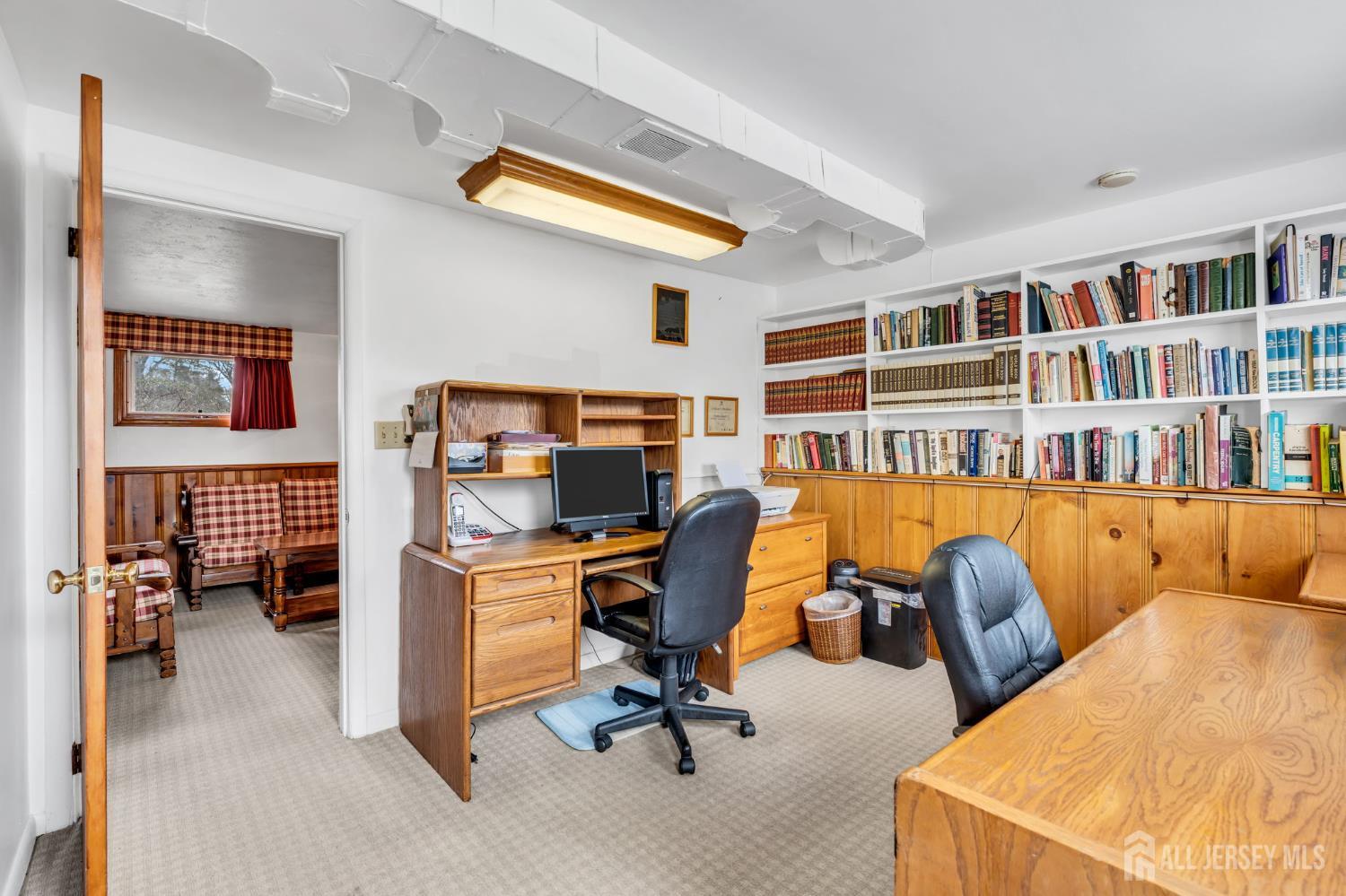 42 Riveredge Road Tinton Falls, NJ 07724 - Photo 34 of 41 a view of a workspace with furniture and a bookshelf