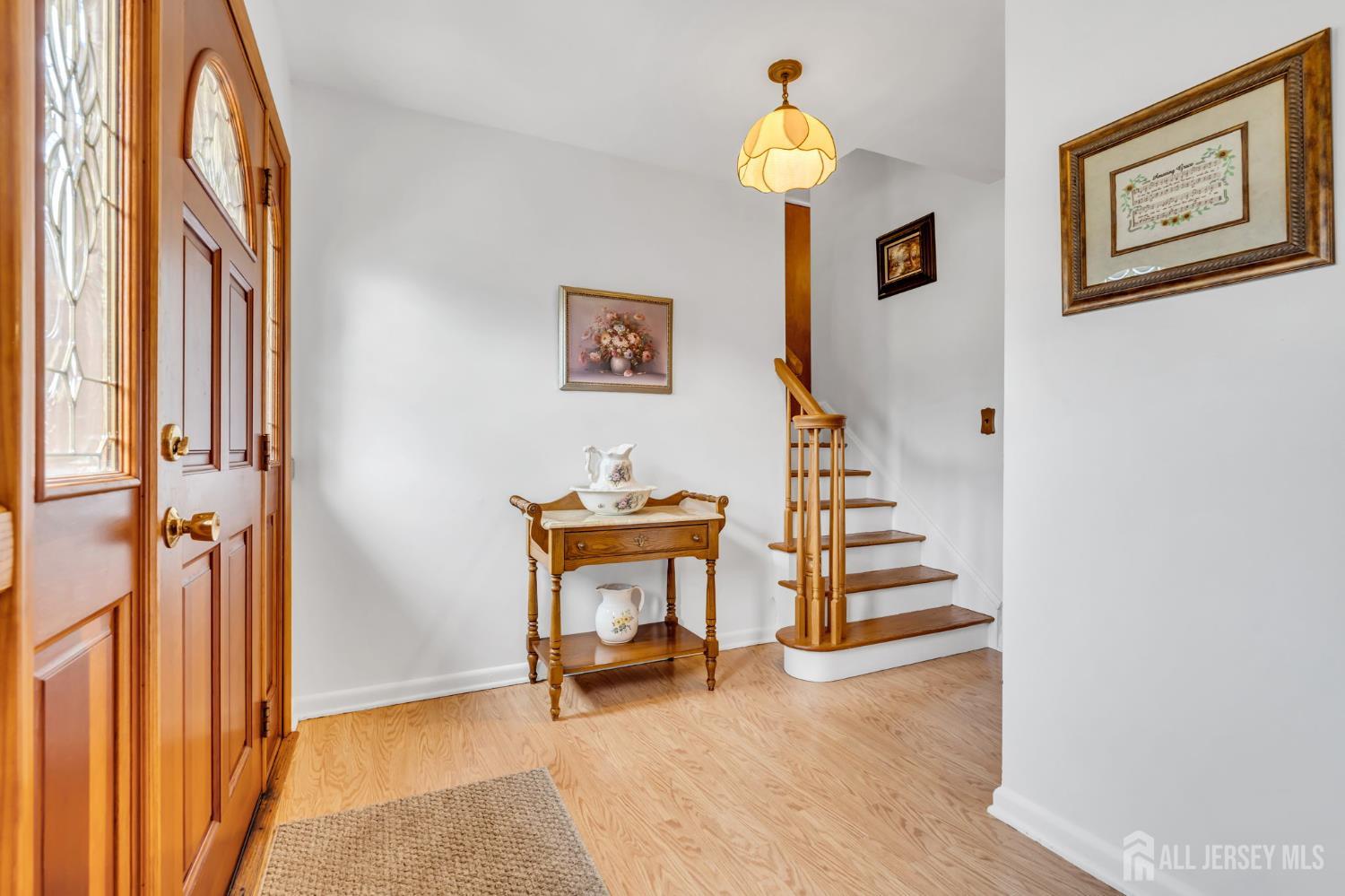 42 Riveredge Road Tinton Falls, NJ 07724 - Photo 4 of 41 a view of a hallway with front door and wooden floor