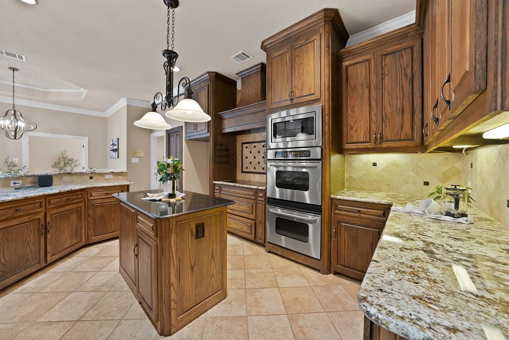 1110 McCampbell Road Mansfield, TX 76063 - Photo 3 of 39 a kitchen with stainless steel appliances granite countertop a stove and a sink