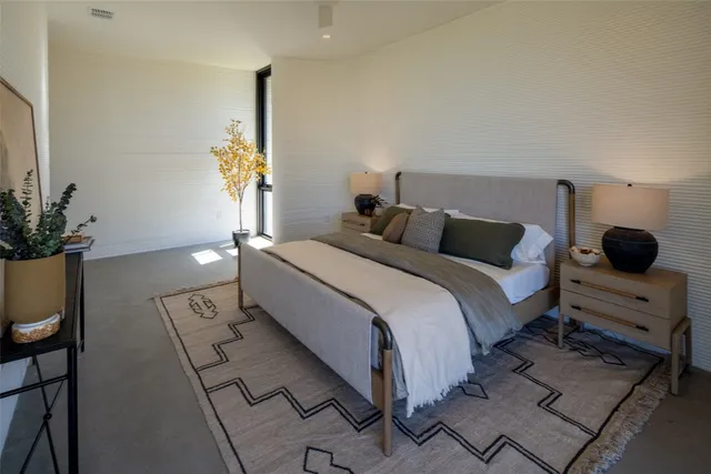 a bedroom with a bed and a potted plant