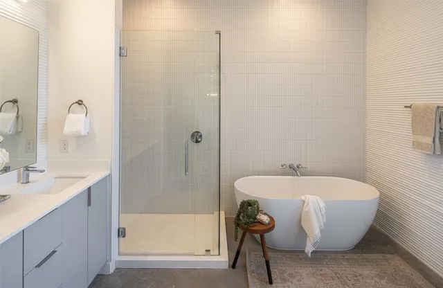a spacious bathroom with a bathtub and sink
