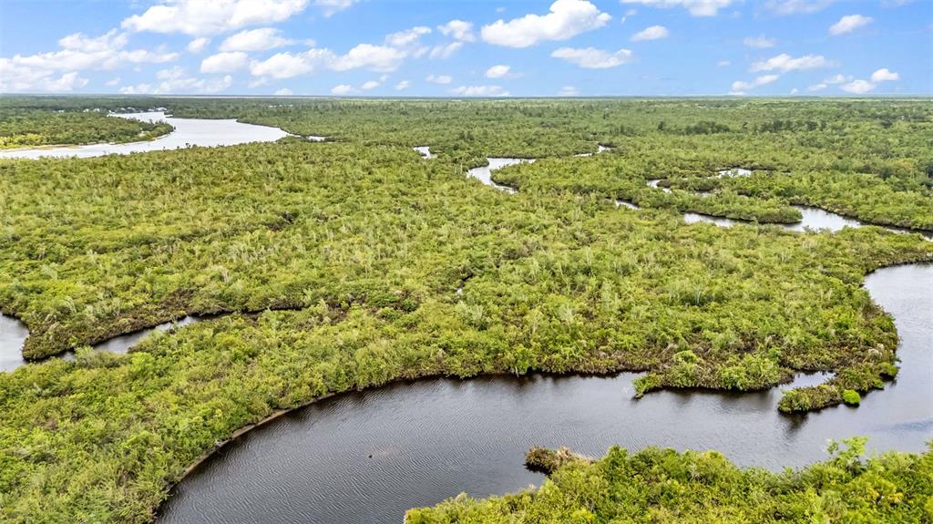 Southwest Sunnybreeze Road Arcadia, FL 34269 - Photo 30 of 50 a view of a lake with a yard