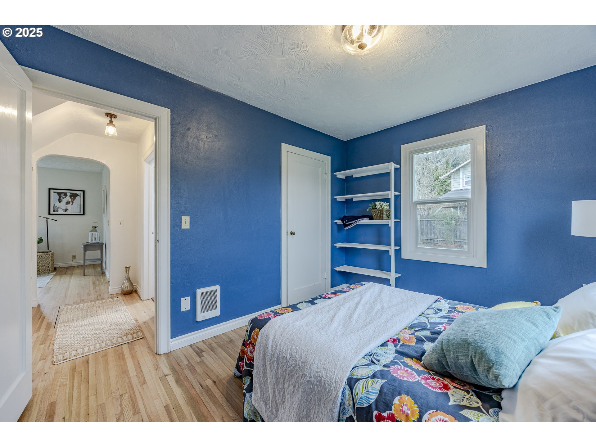 3797 Kincaid Street Eugene, OR 97405 - Photo 23 of 37 a bedroom with a large bed and a chandelier