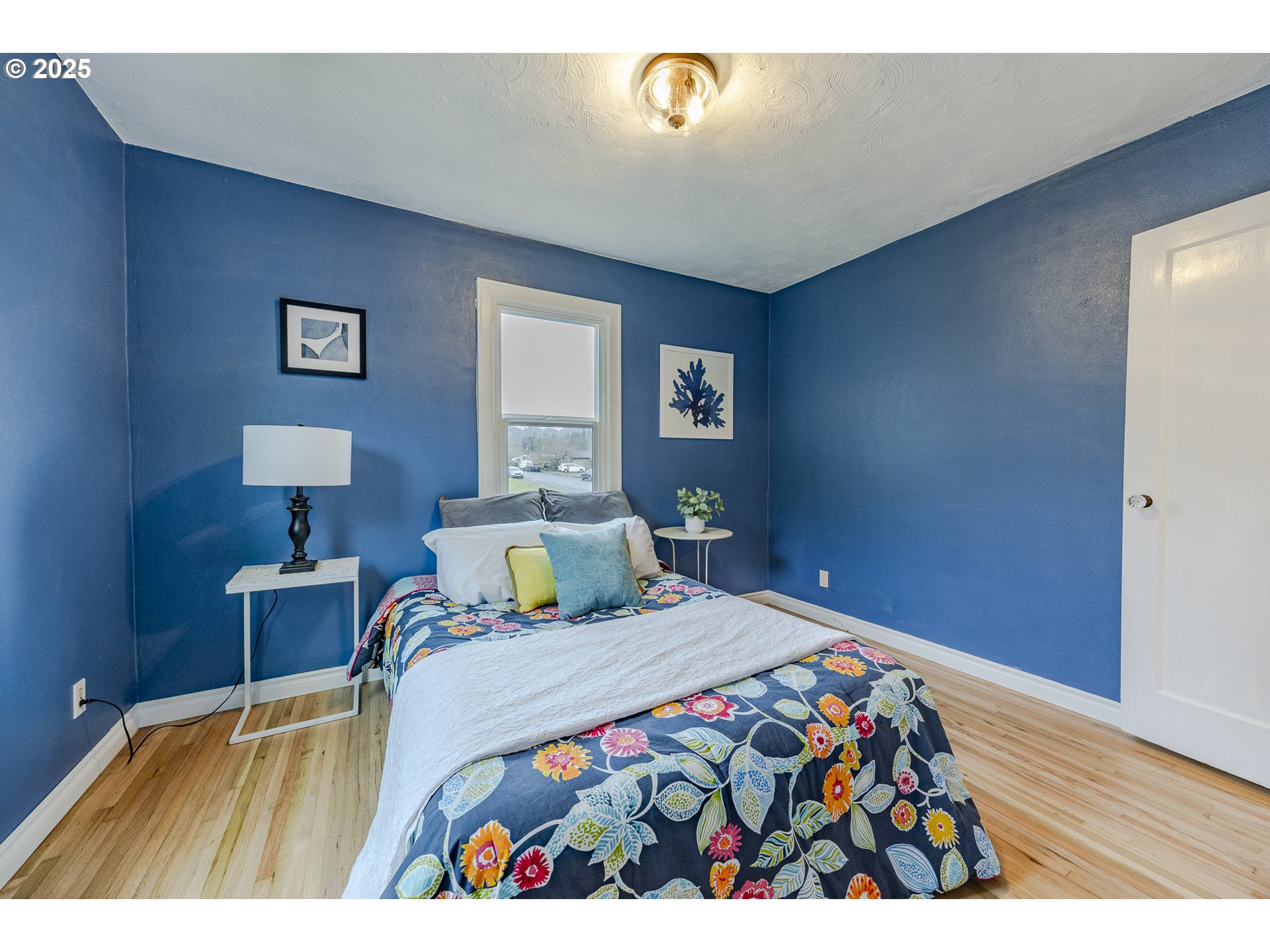 3797 Kincaid Street Eugene, OR 97405 - Photo 25 of 37 a bedroom with a bed and wooden floor