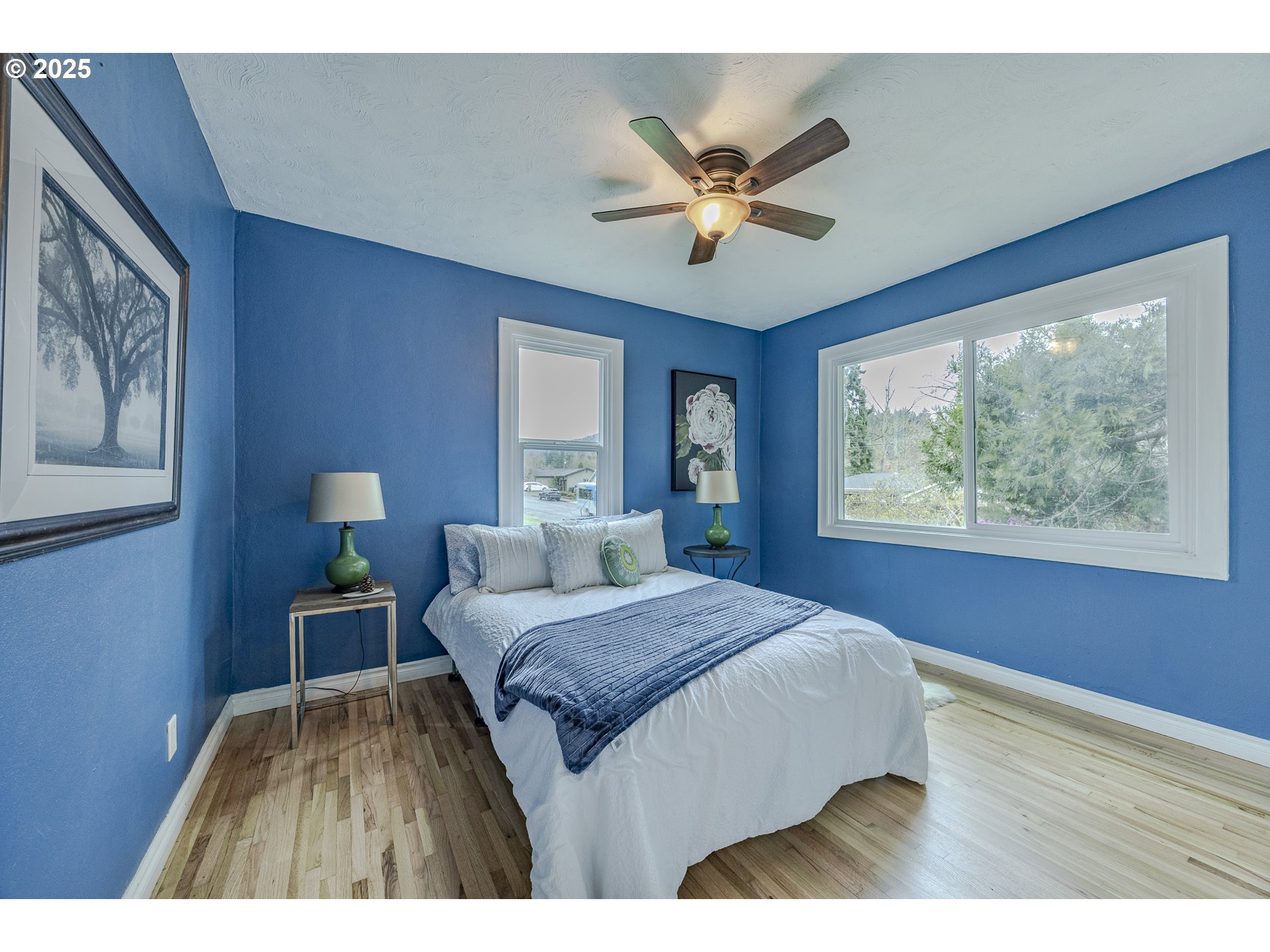 3797 Kincaid Street Eugene, OR 97405 - Photo 29 of 37 a bedroom with a large bed and a chandelier