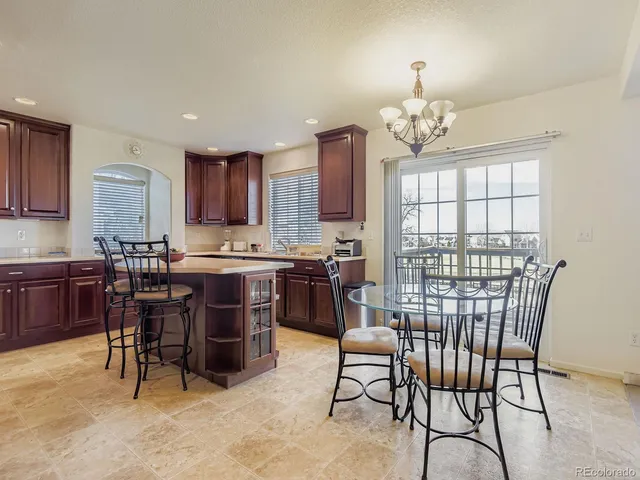 a view of a dining room with furniture and chandelier