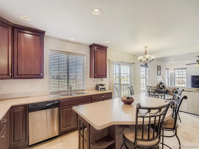a view of a a dining room with furniture window and wooden floor