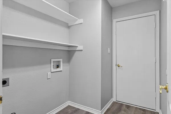 a large kitchen with stainless steel appliances kitchen island granite countertop a refrigerator and a stove top oven