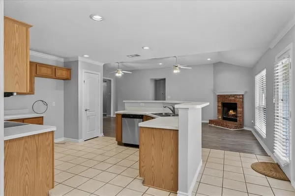a kitchen with a sink a stove cabinets and stainless steel appliances