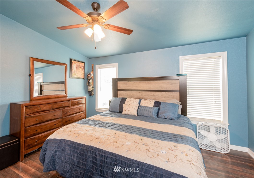 6565 Old Guide Road Bellingham, WA 98226 - Photo 16 of 27 a bedroom with a bed and a chandelier