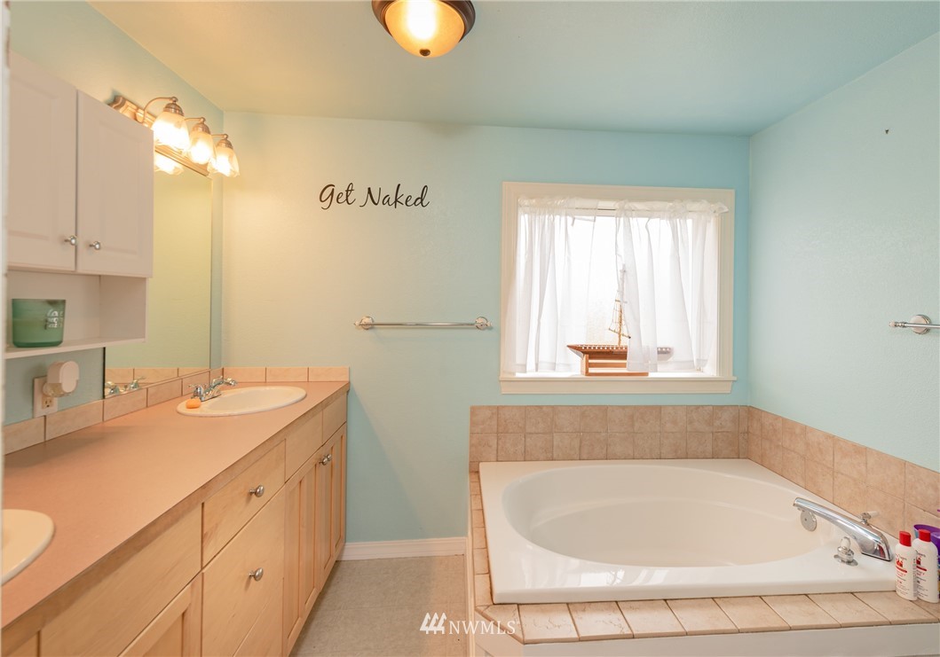 6565 Old Guide Road Bellingham, WA 98226 - Photo 17 of 27 a bathroom with a tub sink and mirror
