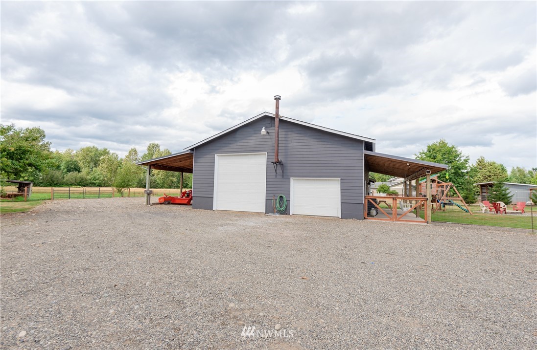 6565 Old Guide Road Bellingham, WA 98226 - Photo 5 of 27 a view of a house with backyard and parking area