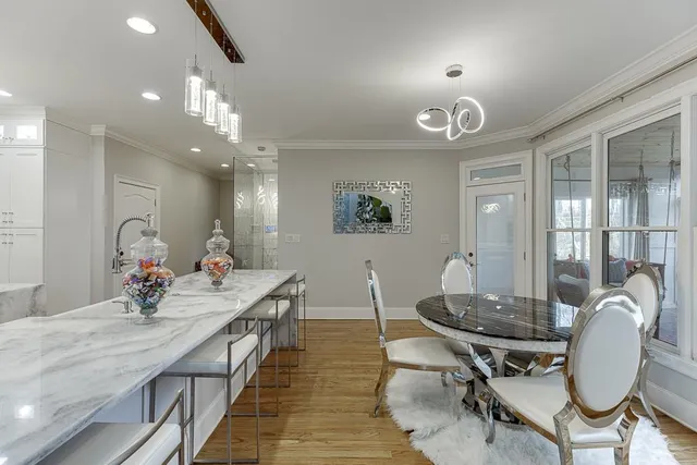 a kitchen with a sink dining table and chairs
