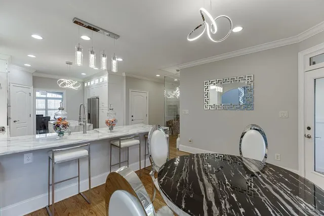 a view of a hallway with wooden floor and windows in a room