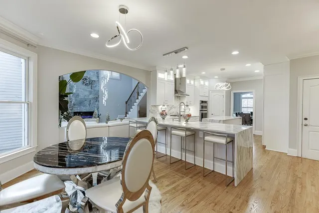 a large kitchen with stainless steel appliances kitchen island granite countertop a large island in the center