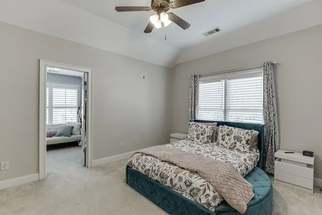 a spacious bathroom with a shower sink and mirror