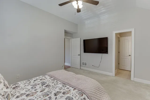 a kitchen with a table chairs refrigerator and cabinets