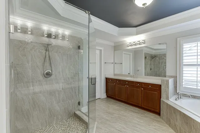 a front view of a house with a yard and potted plants