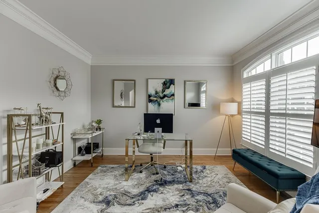a living room with furniture a rug and a window