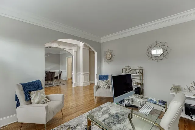a living room with furniture and wooden floor