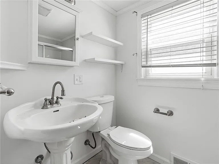 85 Manistee Street Pawtucket, RI 02861 - Photo 5 of 12 a white sink sitting next to a white toilet